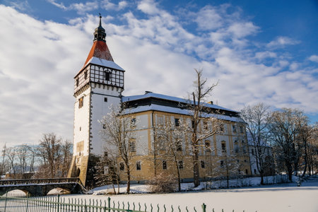 Medieval renaissance water castle with half-timbered tower with snow in winter sunny day, Historic Romantic chateau Blatna near Strakonice in southern Bohemia, Czech Republic, January 09, 2021のeditorial素材