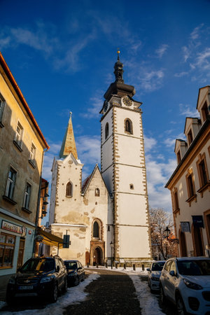Three-nave Gothic basilica, Deanery church of the Nativity of the Blessed Virgin Mary, Architecture of medieval town, Clock tower and bell, Pisek, Southern Bohemia, Czech Republic, January 09, 2021のeditorial素材