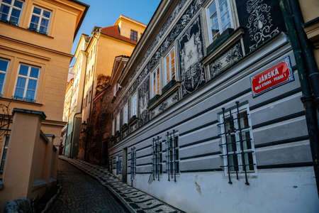 Fascinating narrow picturesque street Jansky vrsek with baroque and renaissance historical house richly decorated with sgraffito, sunny day at Lesser Town, Prague, Czech Republic, December 31, 2020のeditorial素材