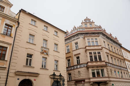 Nerudova street with baroque and renaissance buildings, Fragner's Pharmacy U Cerneho orla, at Lesser Town Square, Malostranske namesti, snow in winter day, Prague, Czech Republic, January 12, 2021のeditorial素材