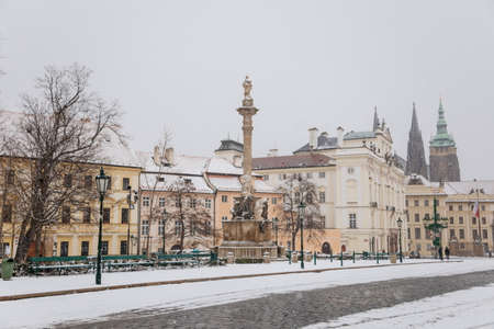 Castle from Hradcany Square, spiers of st Vitus cathedral, archbishop's palace and Marian Plague Column, snow in winter day, Hradcanske namesti, Prague, Czech Republic, January 12, 2021のeditorial素材