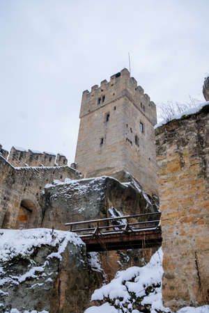 Scenic view of ancient ruins of old gothic medieval castle Helfenburk u Usteka with stone tower under snow in winter day, battlement ring walls, North Bohemia, Czech Republic, January 16, 2021のeditorial素材