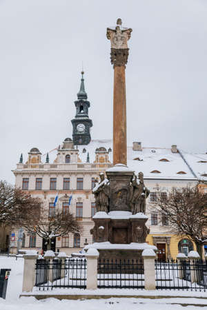 City hall with clock tower and Column with sculptural group of the Holy Trinity on TG Masaryk Square under snow in winter day, Ceska Lipa, North Bohemia, Czech Republic, January 16, 2021のeditorial素材