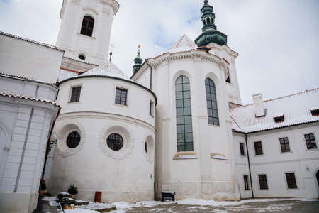 Strahov Monastery with White Baroque church, Premonstratensian abbey in Bohemia under snow, Basilica...