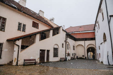 Renaissance courtyard, Baroque medieval castle with stone gothic tower, historical building on the Otava, snow in winter day, Strakonice, Southern Bohemian region, Czech Republic, January 30, 2021のeditorial素材