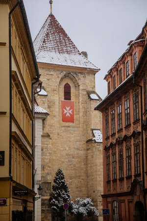 Lazenska street, Stone gothic and romanesque Church of Our Lady beneath the Chain, maltese quarter, snow in winter day, Mala Strana or Lesser Town district, Prague, Czech Republic, January 26, 2021のeditorial素材