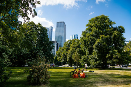 View from Gallusanlage behind the trees, skyscrapers at the financial district, Wall Park in front of the skyline in downtown, Marienturm, green grass, Frankfurt am Main, Germany, July 07, 2019のeditorial素材