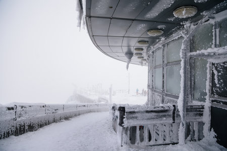 Unique architecture Jested tower covered rough hoarfrost, transmitter and mountain hotel under snow, Frozen bridge, Frosty foggy winter day, Liberec District, Czech Republic, February 13, 2021のeditorial素材