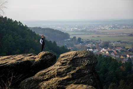 Aerial view from Drabske svetnicky, Autumn sandstone landscape of Bohemian Paradise in sunny day, Sandstone cliffs, man sits on stone, looks into the distance, Czech Republic, December 05, 2020のeditorial素材
