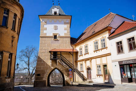 Gothic Priest's Gate or Knezska brana, medieval fortification system, Medieval street, renaissance and baroque historical buildings, sunny day blue sky, Zatec, Bohemia, Czech Republic, April 04, 2021のeditorial素材