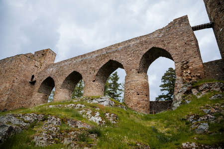 Gothic medieval castle Velhartice in sunny day, tower and stone arch bridge, fortress masonry wall,...