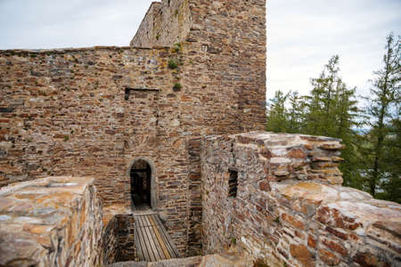 Gothic medieval castle Velhartice in sunny day, tower and stone arch bridge, fortress masonry wall,...