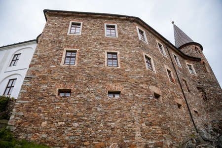 Gothic medieval castle Velhartice in sunny day, tower at the hill near forest, fortress masonry...