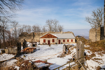 Medieval gothic castle Kostomlaty or Sukoslav under snow, gray stone ruin on hill at sunny winter day, ancient fortress, fairytale stronghold, guard walls, blue sky, Czech Republic, February 20, 2021のeditorial素材