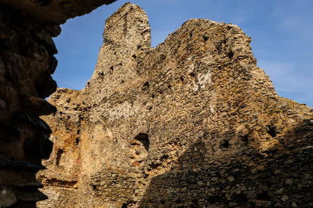 Medieval gothic castle Kostomlaty or Sukoslav under snow, gray stone ruin on hill at sunny winter day, ancient fortress, fairytale stronghold, guard walls, blue sky, Czech Republic, February 20, 2021のeditorial素材