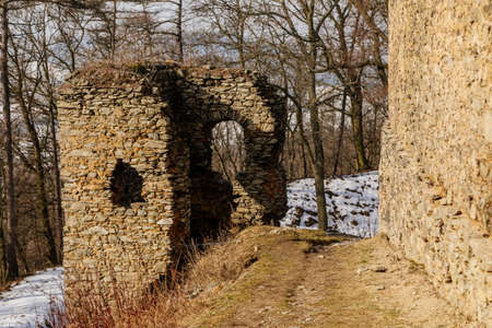 Medieval gothic castle Kostomlaty or Sukoslav under snow, gray stone ruin on hill at sunny winter day, ancient fortress, fairytale stronghold, guard walls, blue sky, Czech Republic, February 20, 2021のeditorial素材