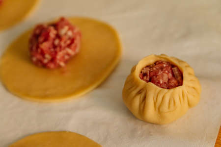 Steamed national Mongolian food dumpling Buuz filled with minced beef, white serviette, wooden...