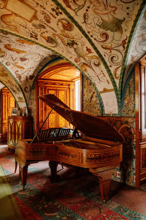 Castle interior, Secession art nouveau style, arched painted ceiling, floral ornaments, wood carved inlaid grand piano, renaissance chateau, Nove mesto nad Metuji, Czech Republic, June 12, 2021のeditorial素材