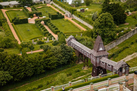 Wonderful covered wooden bridge by Dusan Jurkovic in Italian garden, baroque park in sunny summer day, renaissance chateau castle Nove mesto nad Metuji, Eastern Bohemia, Czech Republic, June 12, 2021のeditorial素材