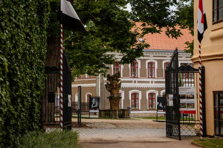 Sculpture of St. Florian, View of Trckovo square with cobble street, colorful houses, tree and green lawn on sunny summer day, historic center, medieval city Opocno, Czech Republic, June 12, 2021のeditorial素材