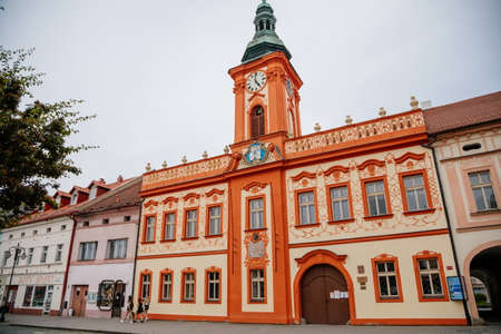 Rakovnik, Central Bohemian region, Czech Republic, 19 June 2021: Baroque red and beige town hall with clock tower at main Husove Square, coat of arms of the city above entrance.のeditorial素材