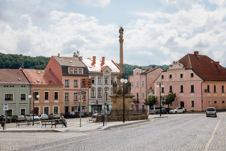 Benesov nad Ploucnici, North Bohemia, Czech Republic, 26 June 2021: Marian Column with baroque statues at main town square, old baroque historic buildings and Town Hall at summer sunny day.のeditorial素材