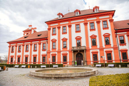 Prague, Czech Republic, 25 April 2021: Troja castle, Historical chateau and red and white baroque palace surrounded by a garden at spring day, staircase decorated with stone sculptures.のeditorial素材
