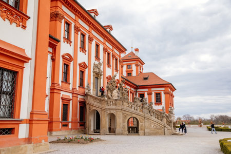 Prague, Czech Republic, 25 April 2021: Troja castle, Historical chateau and red and white baroque palace surrounded by a garden at spring day, staircase decorated with stone sculptures.のeditorial素材