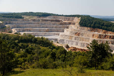 Koneprusy, Czech Republic, 24 July 2021: Deep opencast Limestone mine leaves great environmental impact, calcite quarry in Bohemian karst, landscape near Koneprusy caves in Beroun region.のeditorial素材