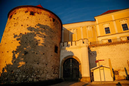 Mikulov, South Moravian Region, Czech Republic, 05 July 2021: Baroque castle or chateau with old stone tower on top of rock with gardens at sunny summer evening, medieval building in center of town.のeditorial素材