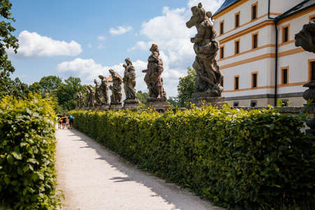 Kuks, East Bohemia, Czech Republic, 10 July 2021: State baroque castle and hospital Kuks with garden and alley of Braun statues, Beautiful complex with chateau and Holy Trinity Church at summer dayのeditorial素材