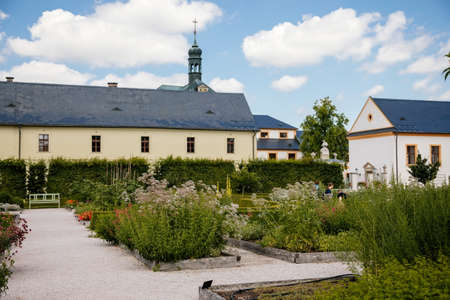 Kuks, East Bohemia, Czech Republic, 10 July 2021: State baroque castle and hospital Kuks with herb garden and Braun statues, Beautiful complex with chateau and Holy Trinity Church at sunny summer dayのeditorial素材