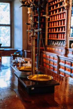 Kuks, East Bohemia, Czech Republic, 10 July 2021: Baroque hospital Kuks, interior of historic pharmacy, Vintage glass bottles on wooden table and shelf, medical background, Museum antique drugstore.のeditorial素材