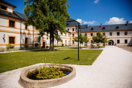 Kuks, East Bohemia, Czech Republic, 10 July 2021: Baroque castle and hospital Kuks, courtyard with garden and antique facade, Beautiful complex with chateau, Holy Trinity Church at sunny summer dayのeditorial素材