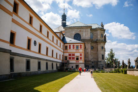 Kuks, East Bohemia, Czech Republic, 10 July 2021: State baroque castle and hospital Kuks with garden and Braun statues, Beautiful complex with chateau and Holy Trinity Church at sunny summer dayのeditorial素材