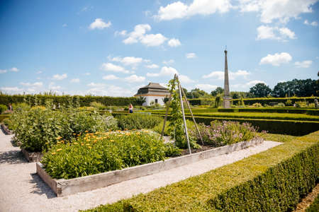 Kuks, East Bohemia, Czech Republic, 10 July 2021: baroque castle and hospital Kuks with herb garden and statues, Beautiful complex with chateau at sunny summer day, flowers, vegetables and fruitsのeditorial素材