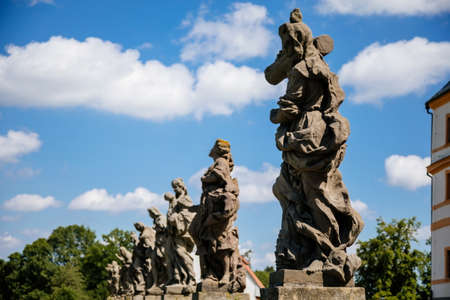 Kuks, East Bohemia, Czech Republic, 10 July 2021: State baroque castle and hospital Kuks with garden and alley of Braun statues, Beautiful complex with chateau and Holy Trinity Church at summer dayのeditorial素材