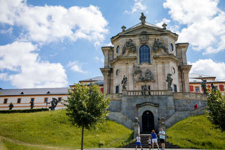 Kuks, East Bohemia, Czech Republic, 10 July 2021: State baroque castle and hospital Kuks with garden and Braun statues, Beautiful complex with chateau and Holy Trinity Church at sunny summer dayのeditorial素材