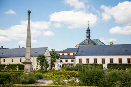 Kuks, East Bohemia, Czech Republic, 10 July 2021: State baroque castle and hospital Kuks with garden and Braun statues, Beautiful complex with chateau and Holy Trinity Church at summer day, Obeliskのeditorial素材