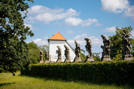 Kuks, East Bohemia, Czech Republic, 10 July 2021: State baroque castle and hospital Kuks with garden and alley of Braun statues, Beautiful complex with chateau and Holy Trinity Church at summer dayのeditorial素材