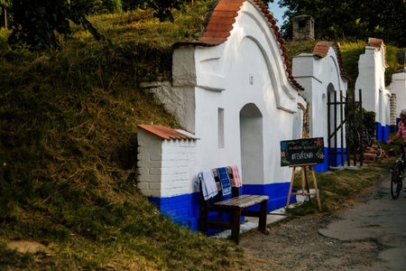Plze, Petrov, Southern Moravia, Czech Republic, 04 July 2021: Group of typical outdoor historic traditional Wine Cellars, Tourist attractions at wine region, white and blue houses at summer sunny day.のeditorial素材
