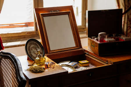 Jaromerice nad Rokytnou, Bohemia, Czech Republic, 06 July 2021: Castle interior with baroque wooden carved furniture, bedroom with wardrobe, ladies dressing table with mirror, perfume and cosmetics.のeditorial素材