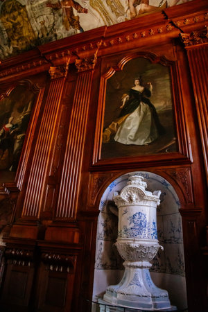 Jaromerice nad Rokytnou, Czech Republic, 06 July 2021: Castle interior with baroque wooden carved furniture, grand hall with wood panels, paintings on the walls, painted ceiling with colored frescoes.のeditorial素材