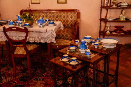 Jaromerice nad Rokytnou, Czech Republic, 06 July 2021: Castle interior with baroque wooden carved furniture, sofa and soft armchairs, porcelain tea set on table, paintings in gilded frames.のeditorial素材
