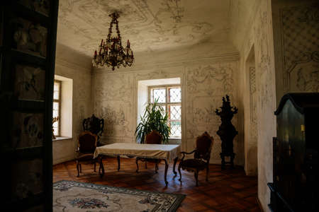 Jaromerice nad Rokytnou, Bohemia, Czech Republic, 06 July 2021: Castle interior with baroque wooden carved furniture, salon painted walls, colored frescoes with floral ornaments, table and chairs.のeditorial素材