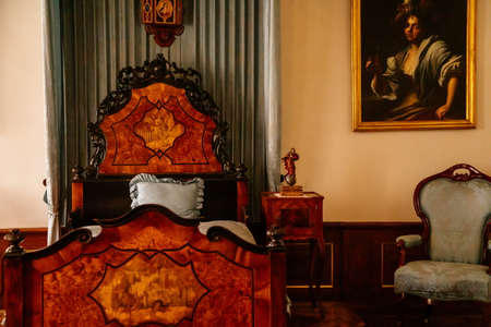 Jaromerice nad Rokytnou, Bohemia, Czech Republic, 06 July 2021: Castle interior with baroque wooden carved furniture, bedroom with canopy bed, beautiful romantic chateau, paintings in gilded frames.のeditorial素材
