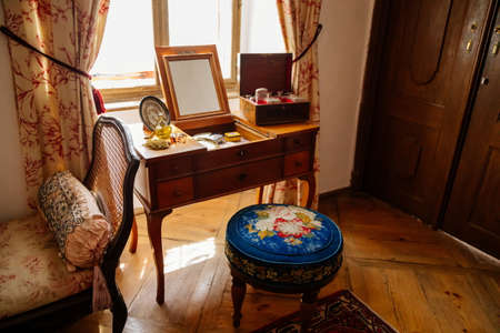 Jaromerice nad Rokytnou, Bohemia, Czech Republic, 06 July 2021: Castle interior with baroque wooden carved furniture, bedroom with wardrobe, ladies dressing table with mirror, perfume and cosmetics.のeditorial素材