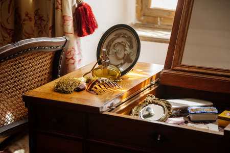 Jaromerice nad Rokytnou, Bohemia, Czech Republic, 06 July 2021: Castle interior with baroque wooden carved furniture, bedroom with wardrobe, ladies dressing table with mirror, perfume and cosmetics.のeditorial素材
