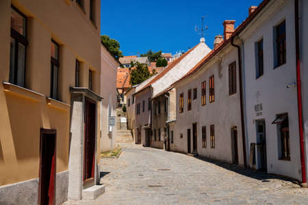 Trebic, Bohemia, Czech Republic, 06 July 2021: Narrow picturesque street with colorful buildings in historic center in medieval city, renaissance and baroque historical buildings at summer sunny day.のeditorial素材