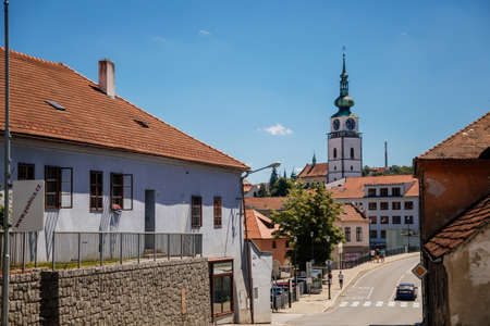 Trebic, Bohemia, Czech Republic, 06 July 2021: Narrow picturesque street with colorful buildings in historic center, renaissance and baroque medieval city, Church of St. Martina at sunny summer day.のeditorial素材